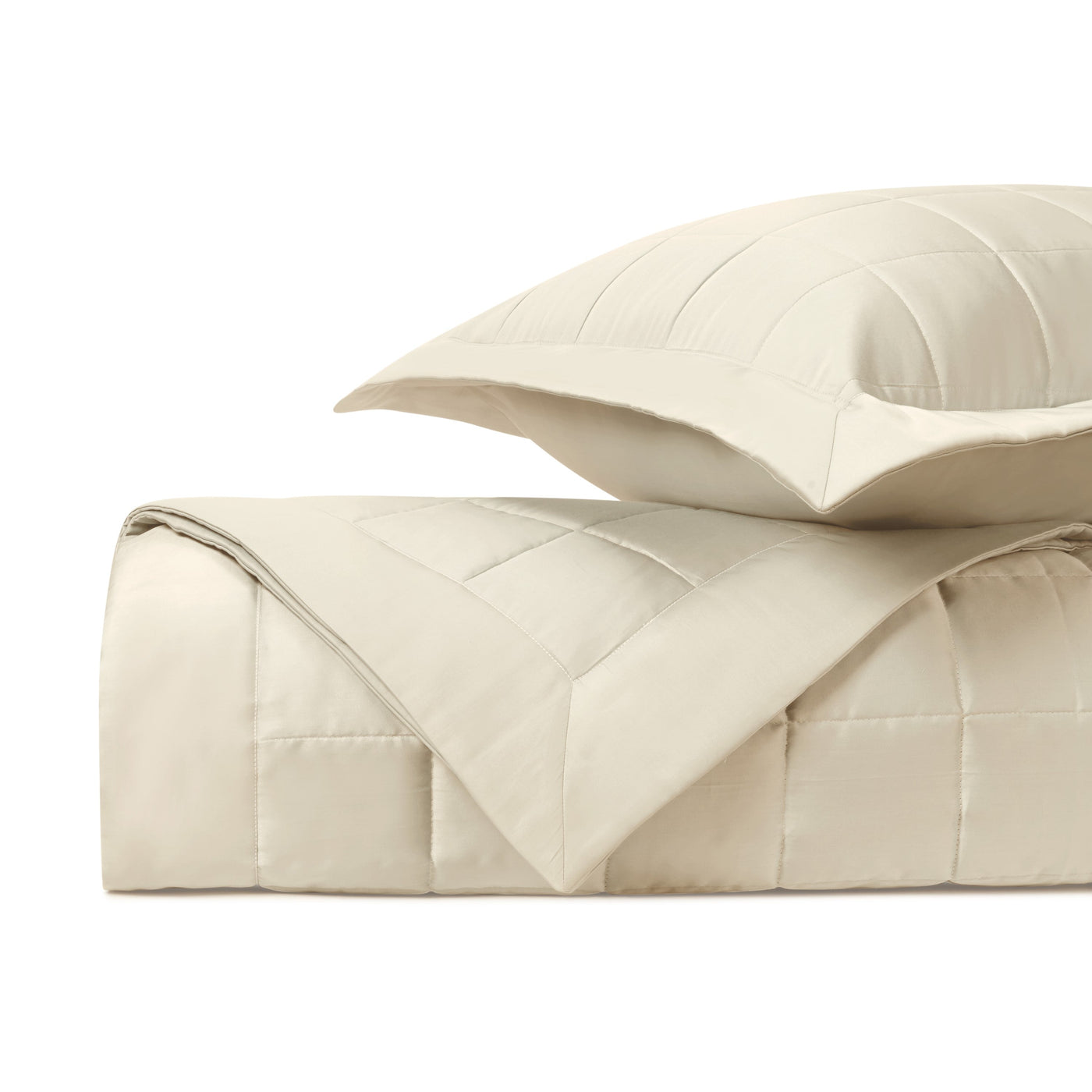 Close-up of Home Treasures Plateau ivory quilted texture with grid stitching detail.