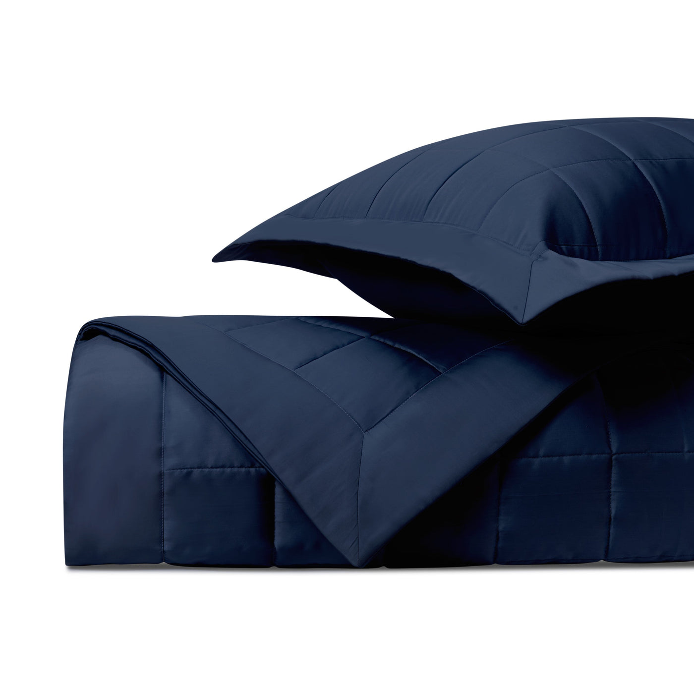 Close-up of Plateau navy quilted comforter and sham showing channel stitching detail.