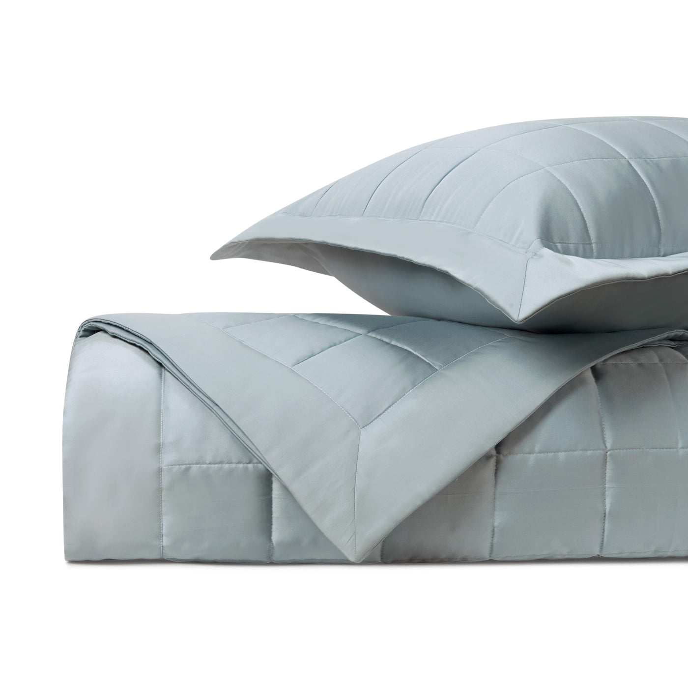 Close-up of Home Treasures Plateau quilted coverlet in mist blue with grid stitching.