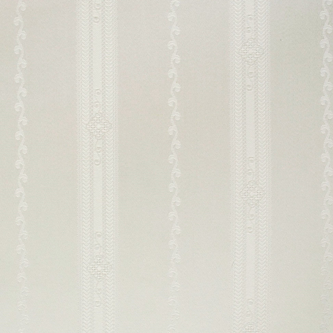Close-up of ivory cotton fabric with tonal woven vertical stripes and embroidered dot detailing.