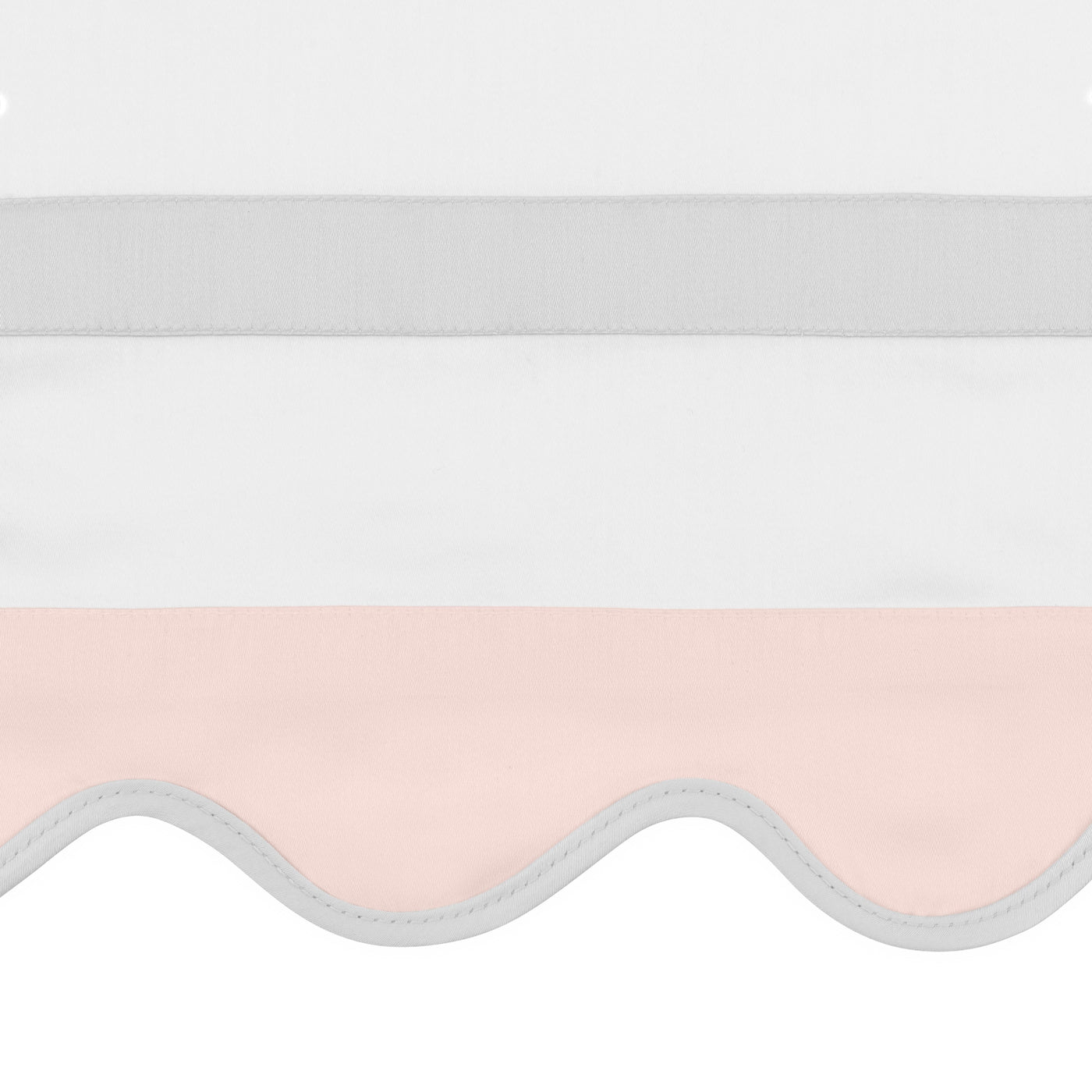 Close-up of scalloped blush edge with grey piping on Home Treasures Portofino pillow sham.