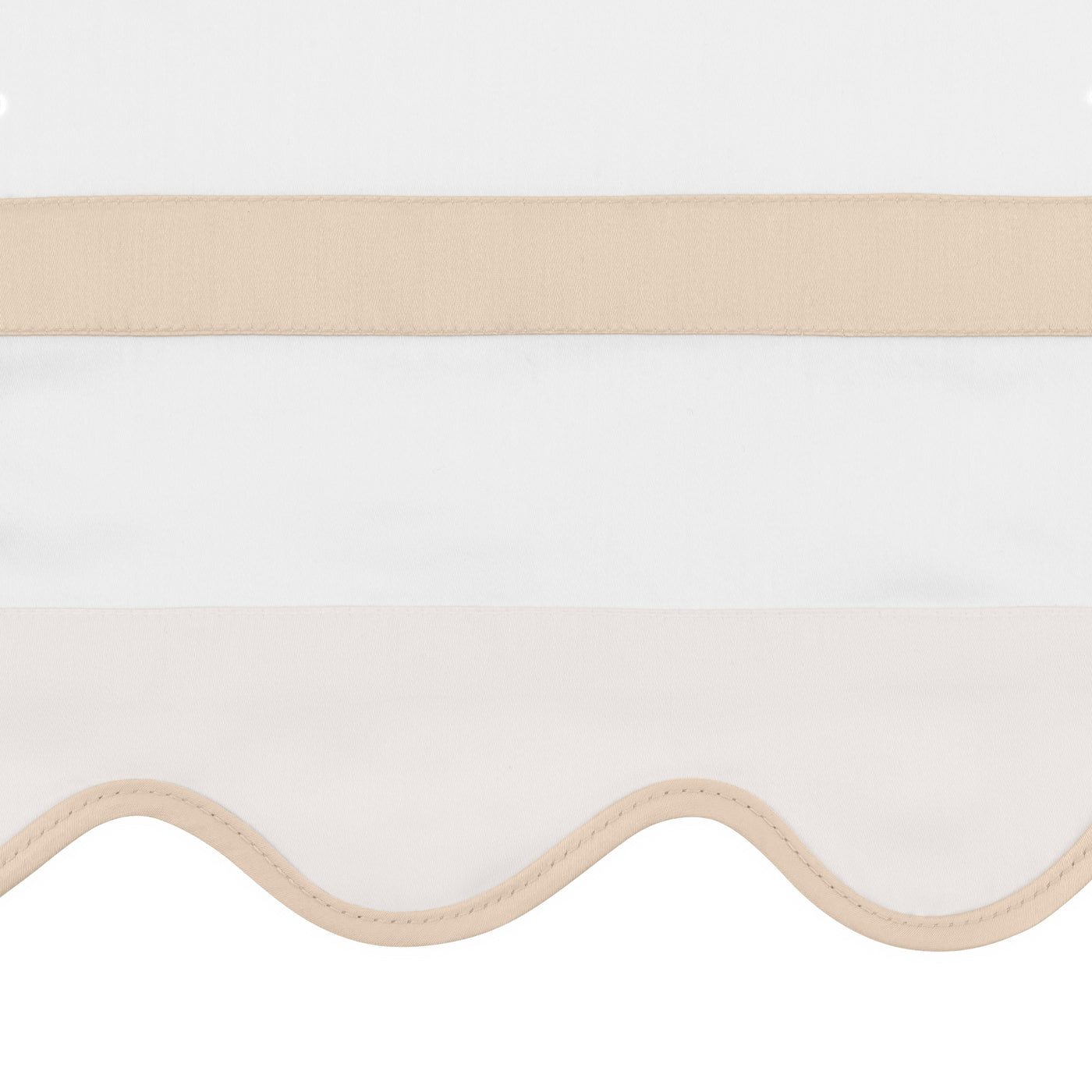 Close-up of scalloped ivory hem with champagne satin border detail.
