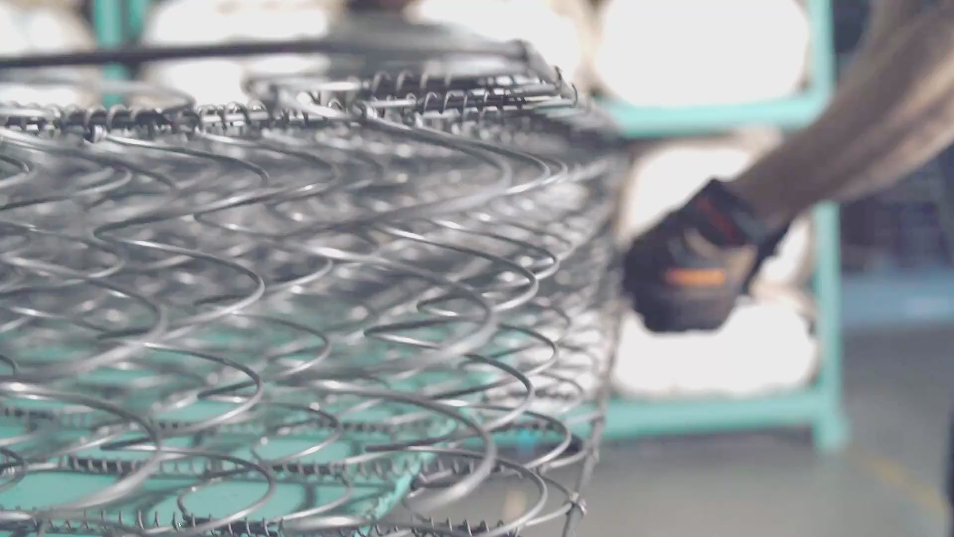 Artisan hands layering natural fibers inside a LETTO mattress