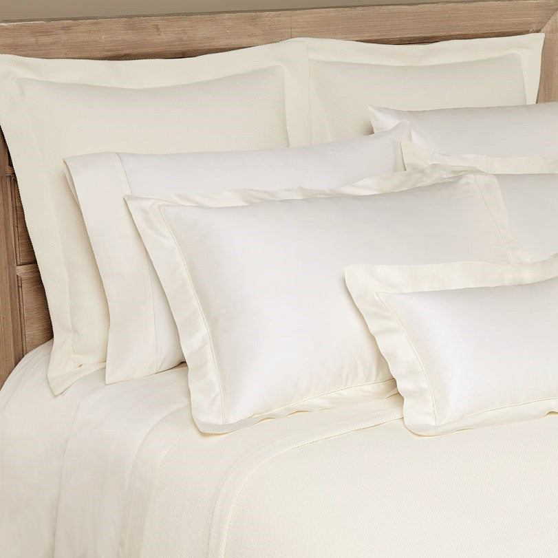 Close-up of Home Treasures Princess ivory bedding with champagne border detail.