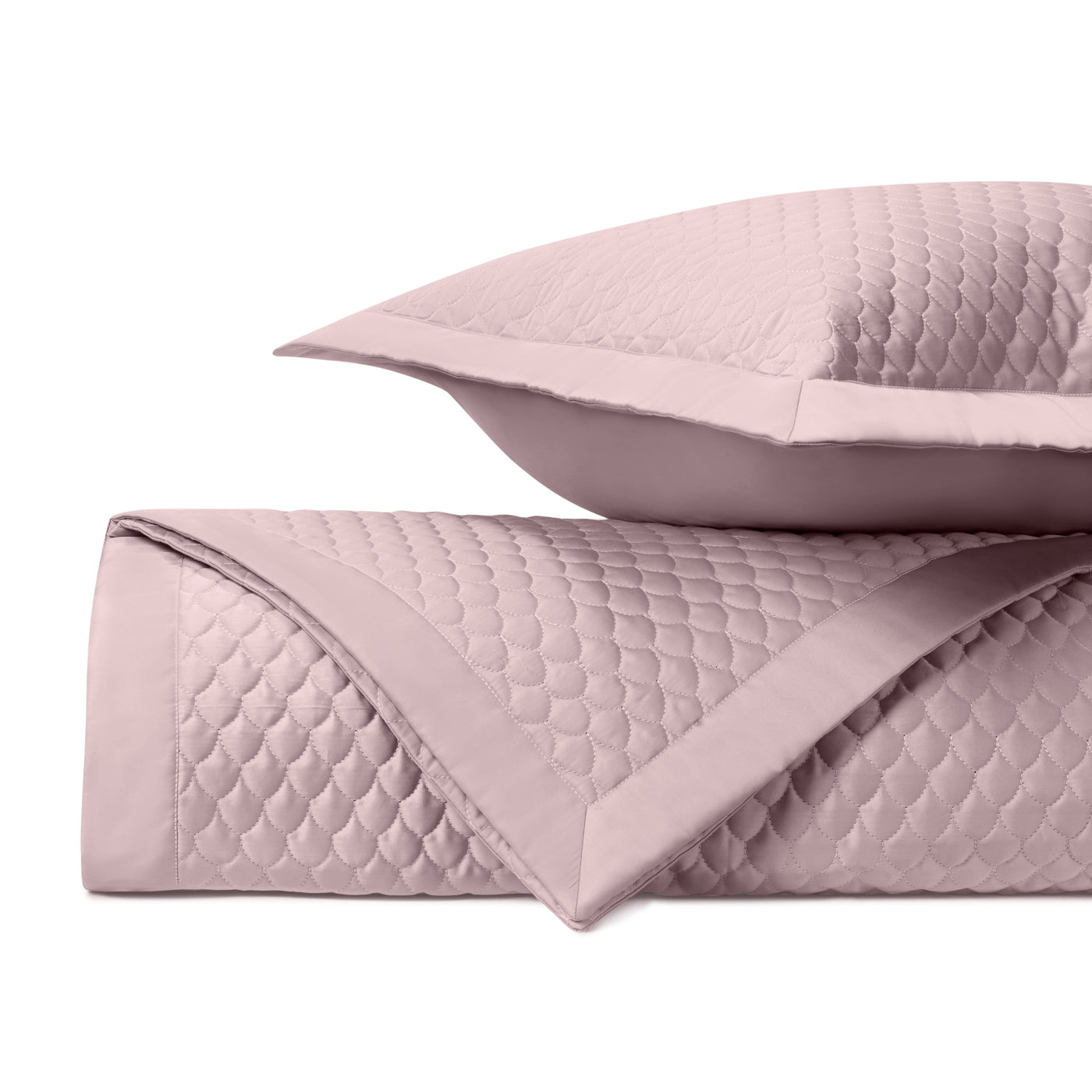 Close-up of blush Raindrop quilted texture with scallop stitching and flat-border sham.