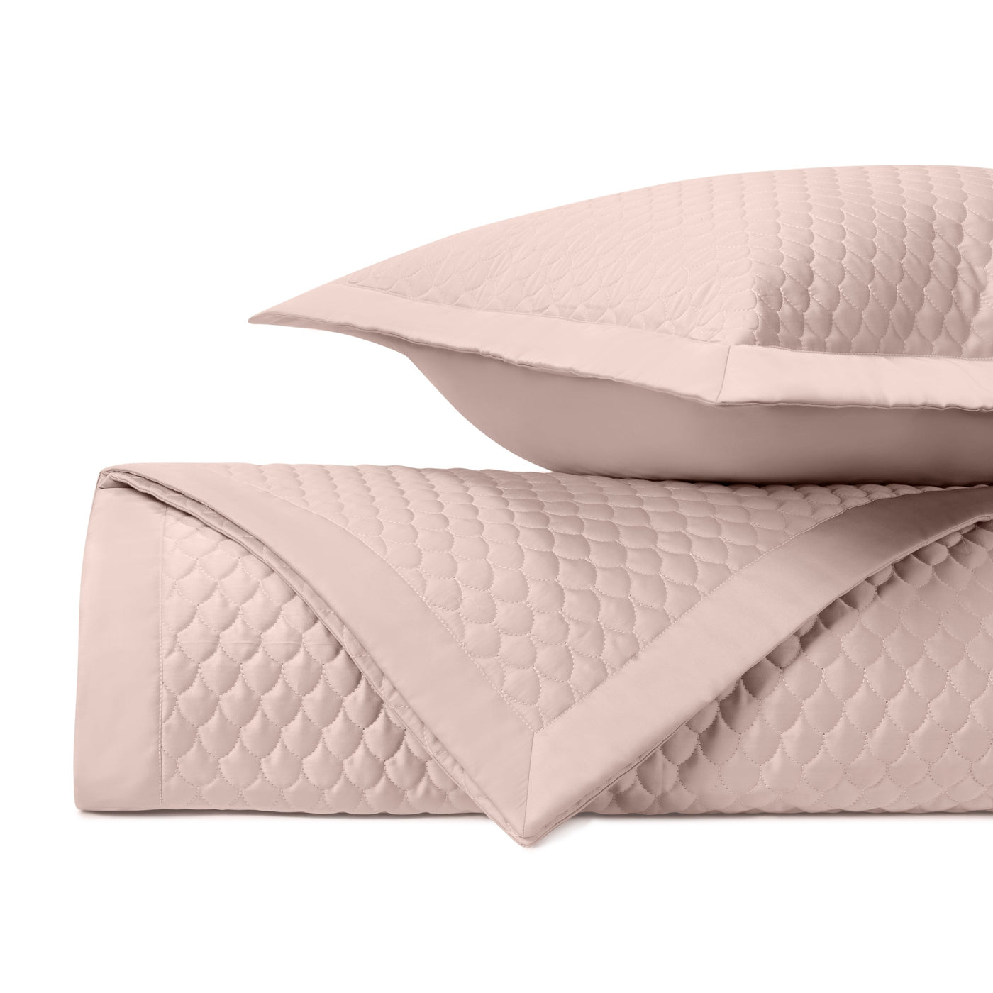 Close-up of Home Treasures Raindrop quilted texture in blush pink with flange-edged sham.