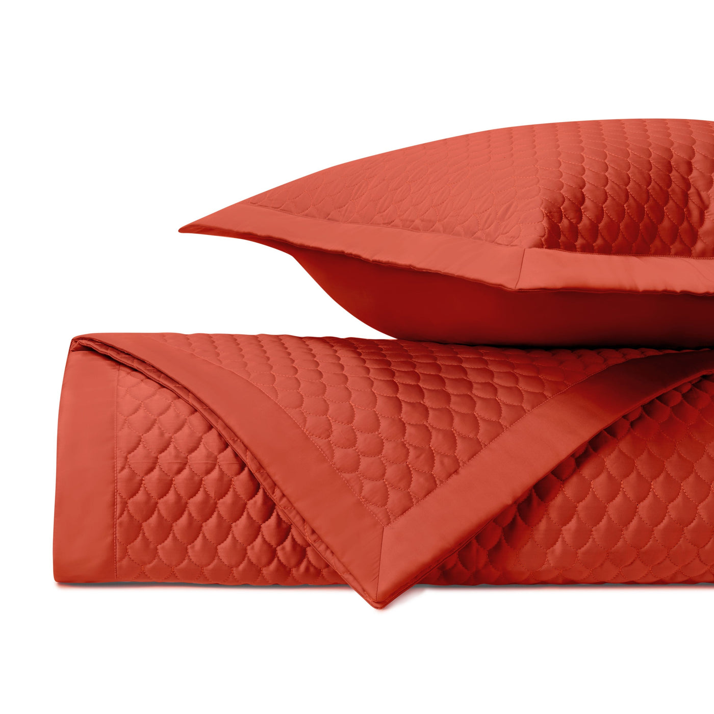 Close-up of Home Treasures Raindrop quilted texture in tomato red with scallop stitching.