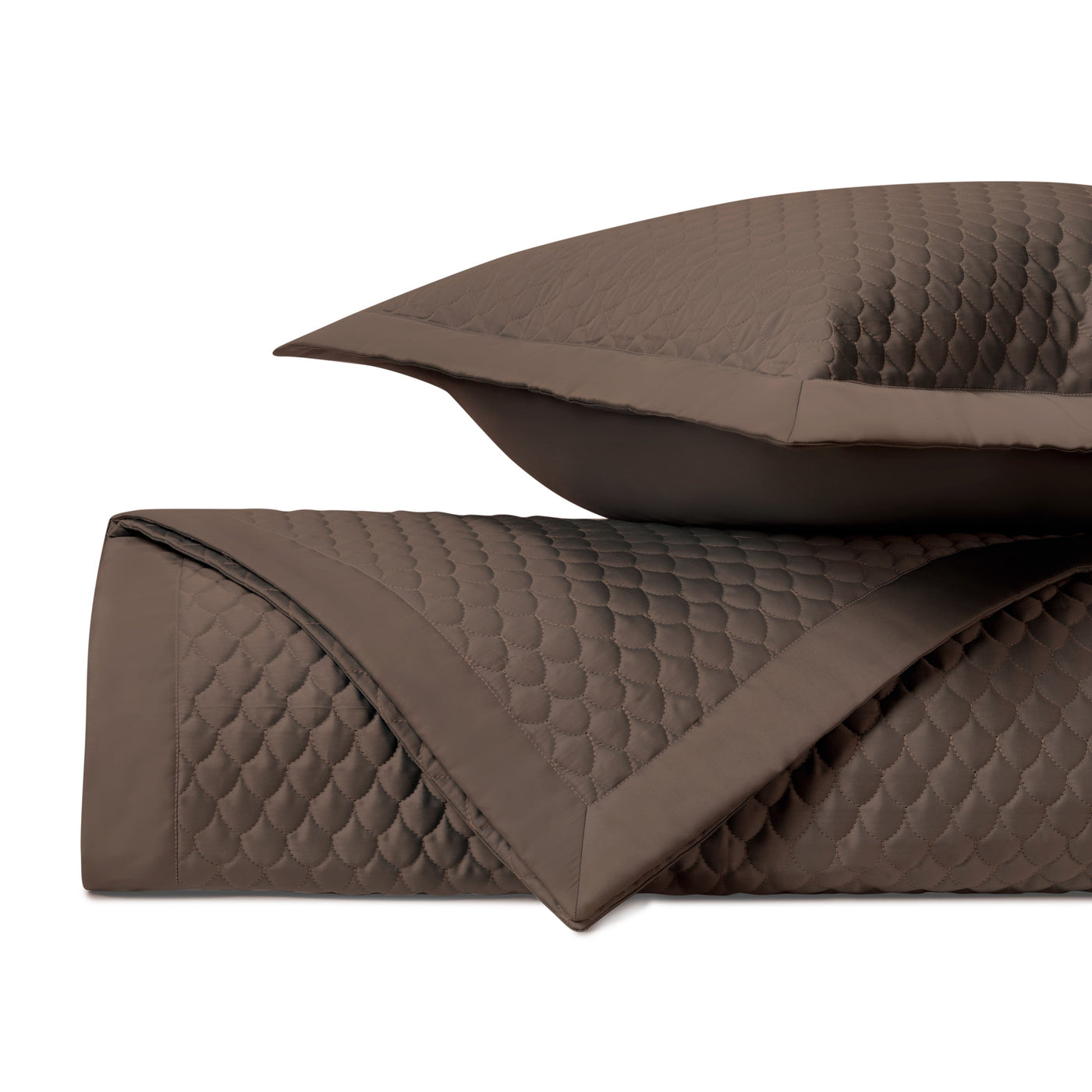 Close-up of Home Treasures Raindrop quilted coverlet in chocolate with scallop stitching.