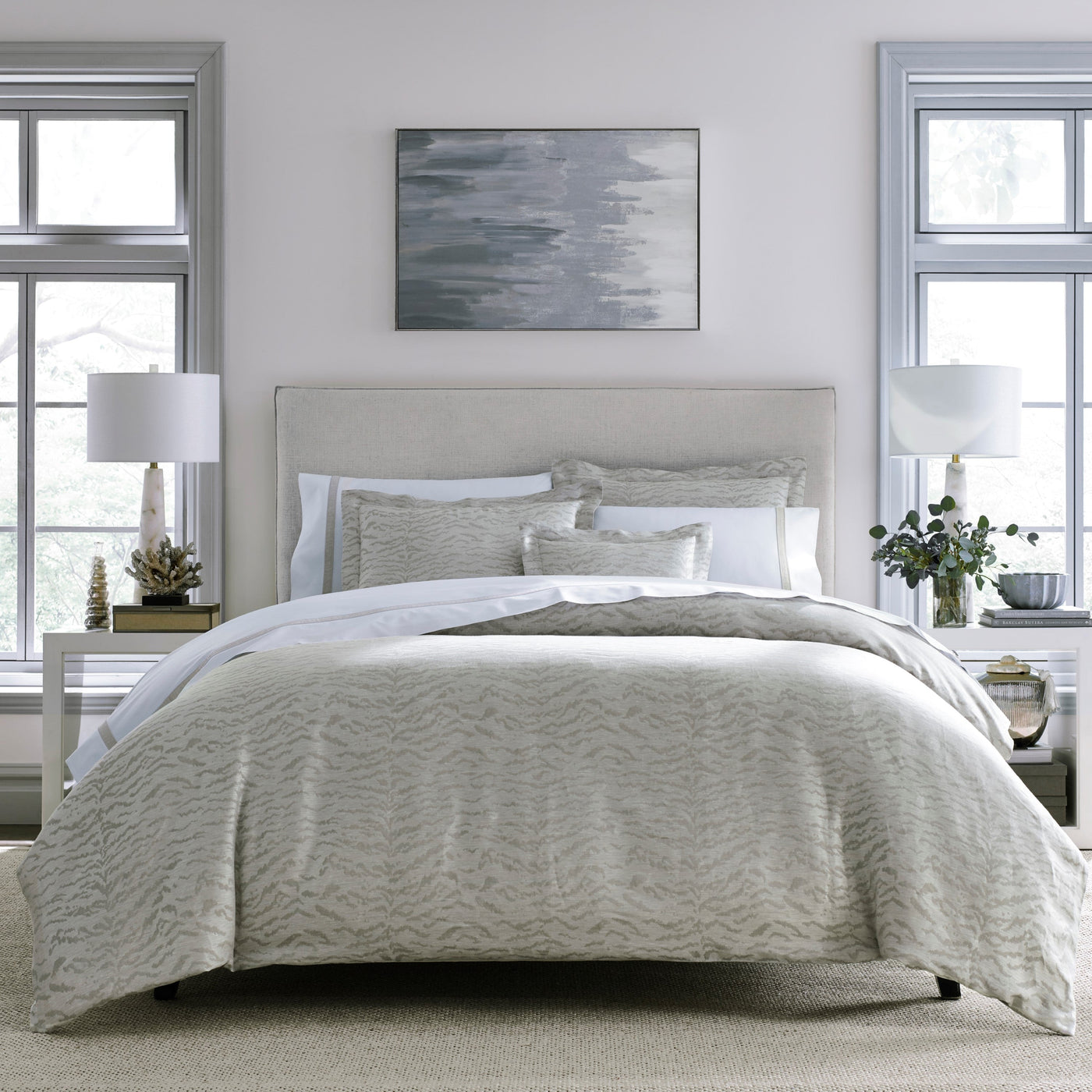 Home Treasures Alina pillowcase in silver-grey with textured wave pattern on styled bed.