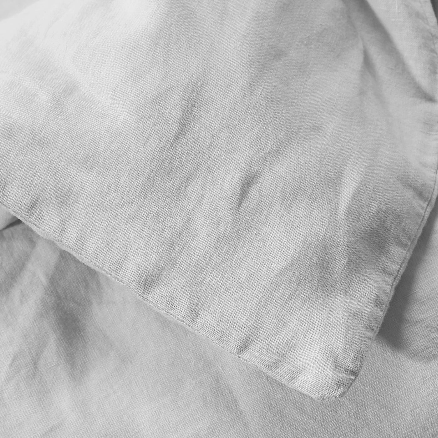 Close-up of Society Limonta Rem duvet cover edge in silver-grey washed linen.