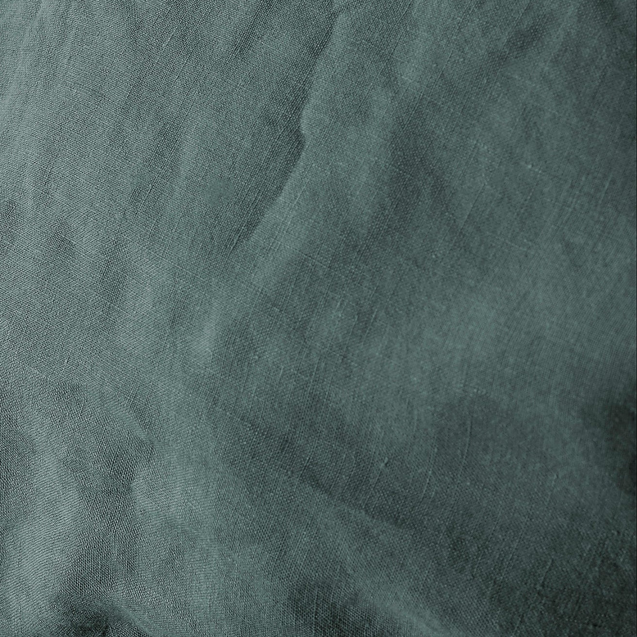 Close-up of Society Limonta Rem linen fabric in slate teal, showing natural texture and drape.
