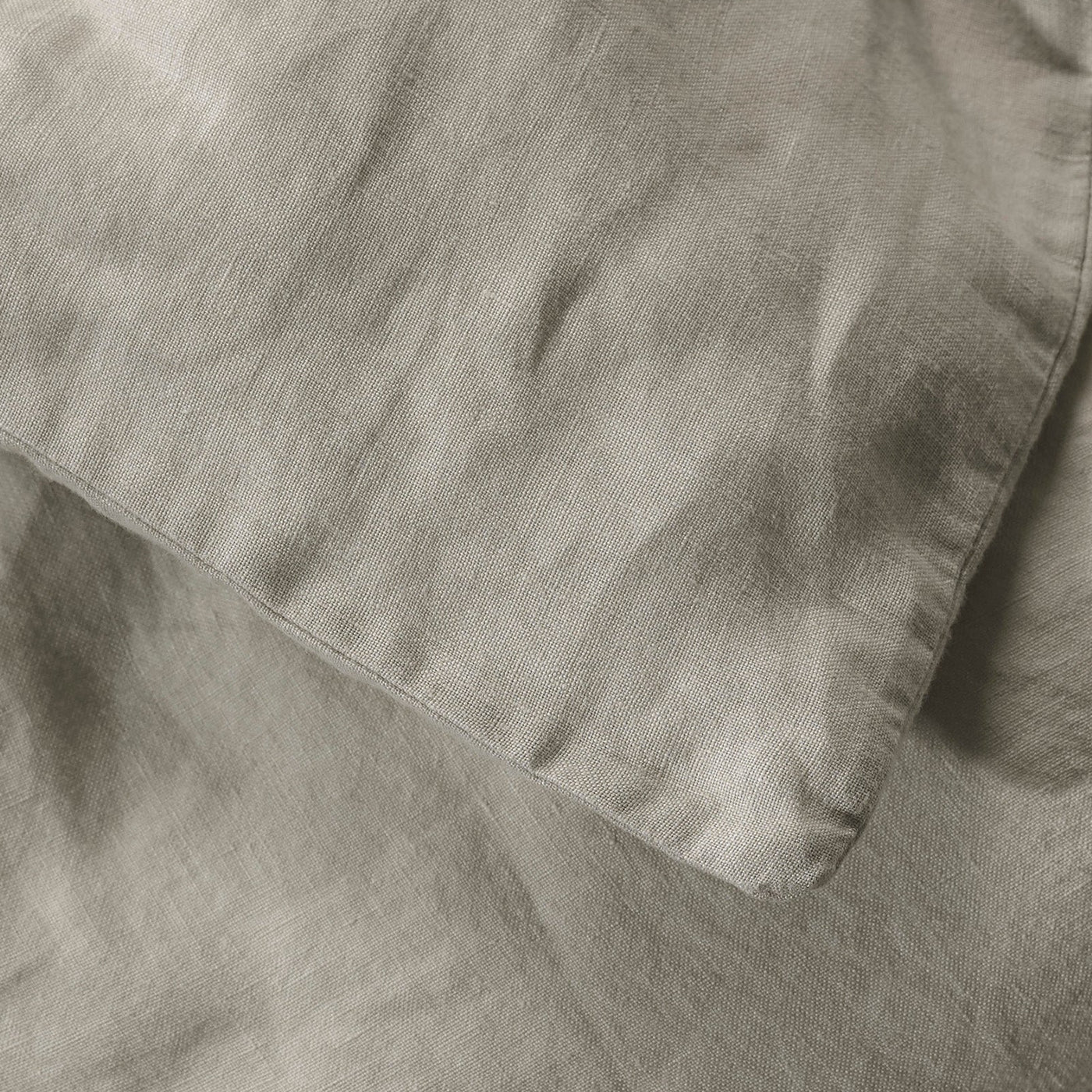 Close-up of Society Limonta Rem duvet cover in taupe linen, showing natural texture and hem detail.