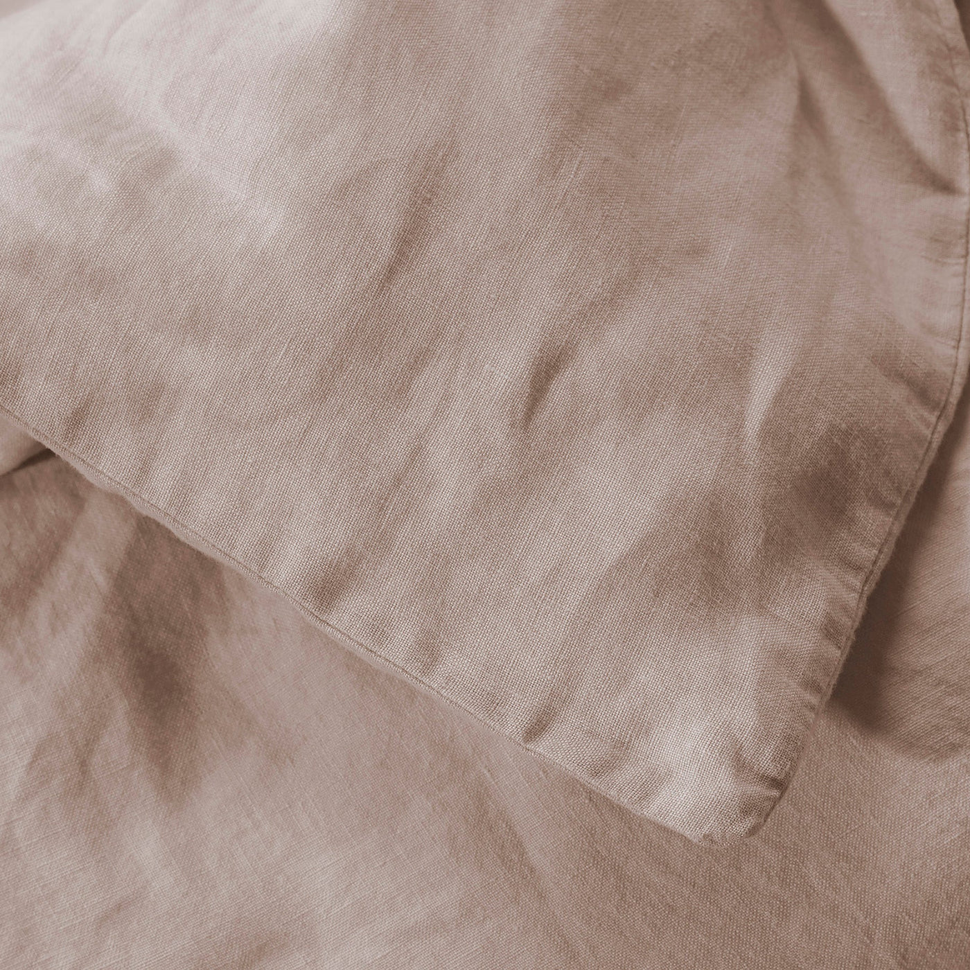 Close-up of Society Limonta Rem duvet cover in taupe linen, showing relaxed texture and corner seam.