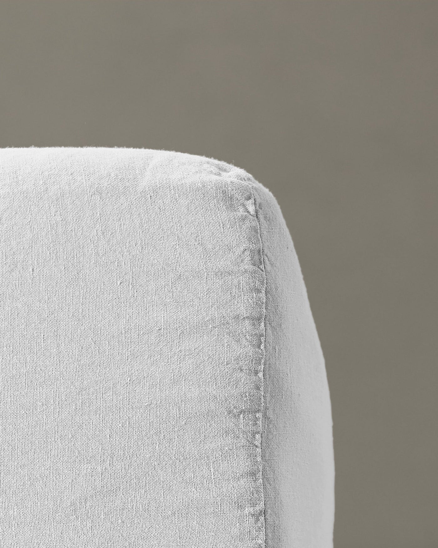 Close-up of Society Limonta Rem fitted sheet corner seam in white linen.