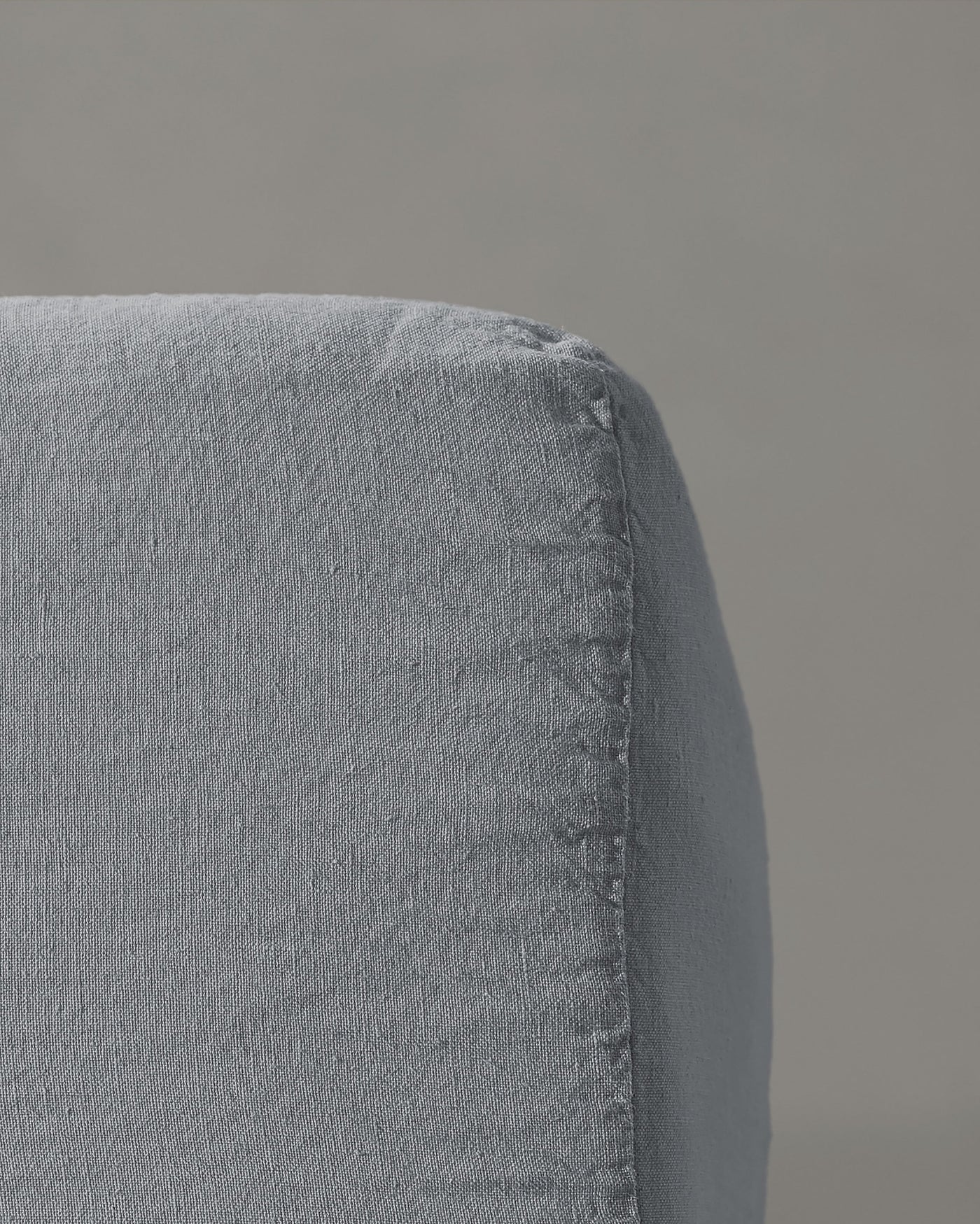 Close-up of Society Limonta Rem fitted sheet corner seam in slate linen.