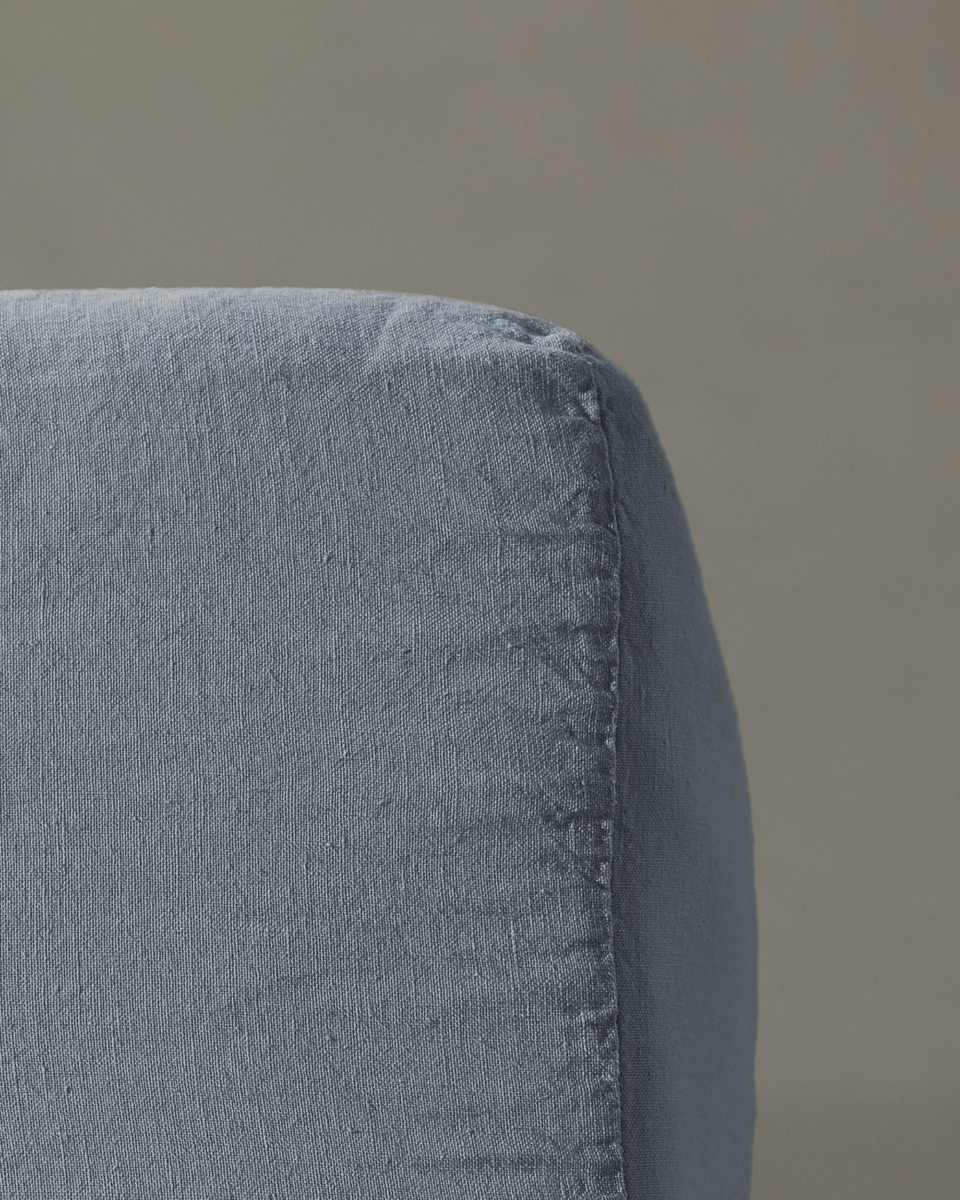 Close-up of Society Limonta Rem fitted sheet corner seam in slate blue linen.