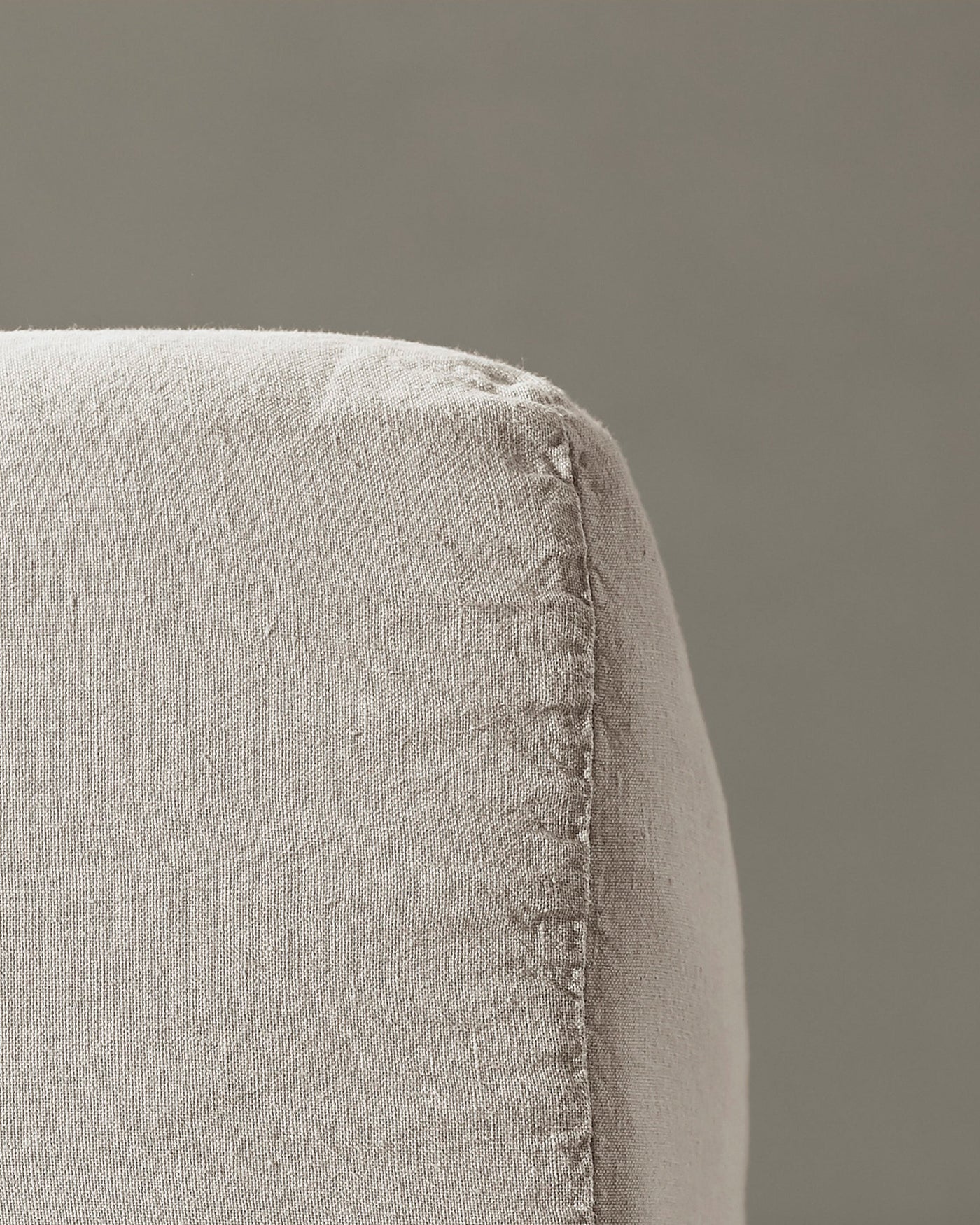 Close-up of Society Limonta Rem fitted sheet corner seam in natural linen.
