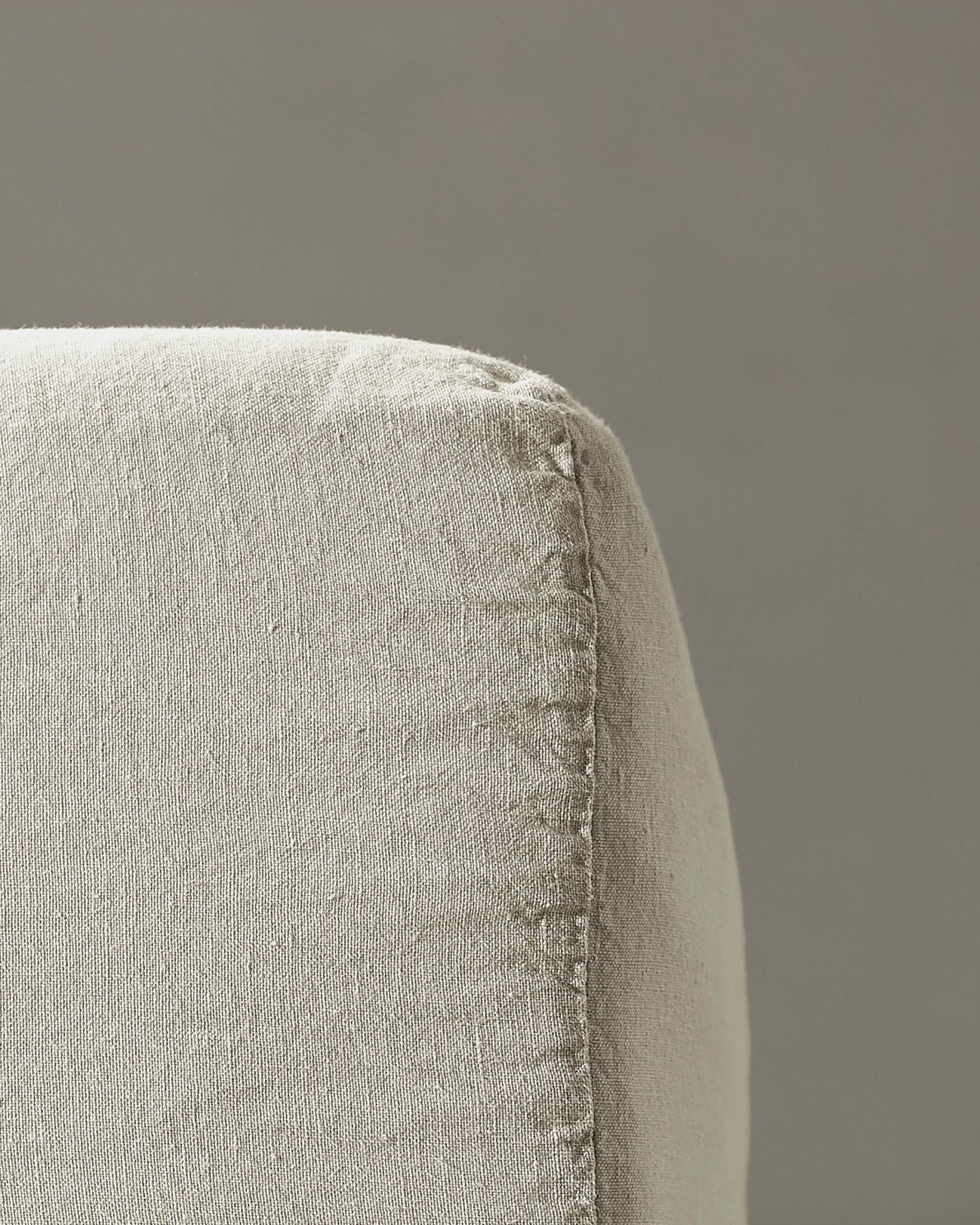 Close-up of Society Limonta Rem fitted sheet corner seam in natural linen.