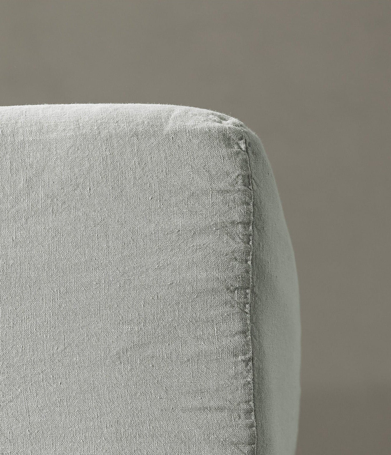 Close-up of Rem fitted sheet corner seam in mist linen fabric.