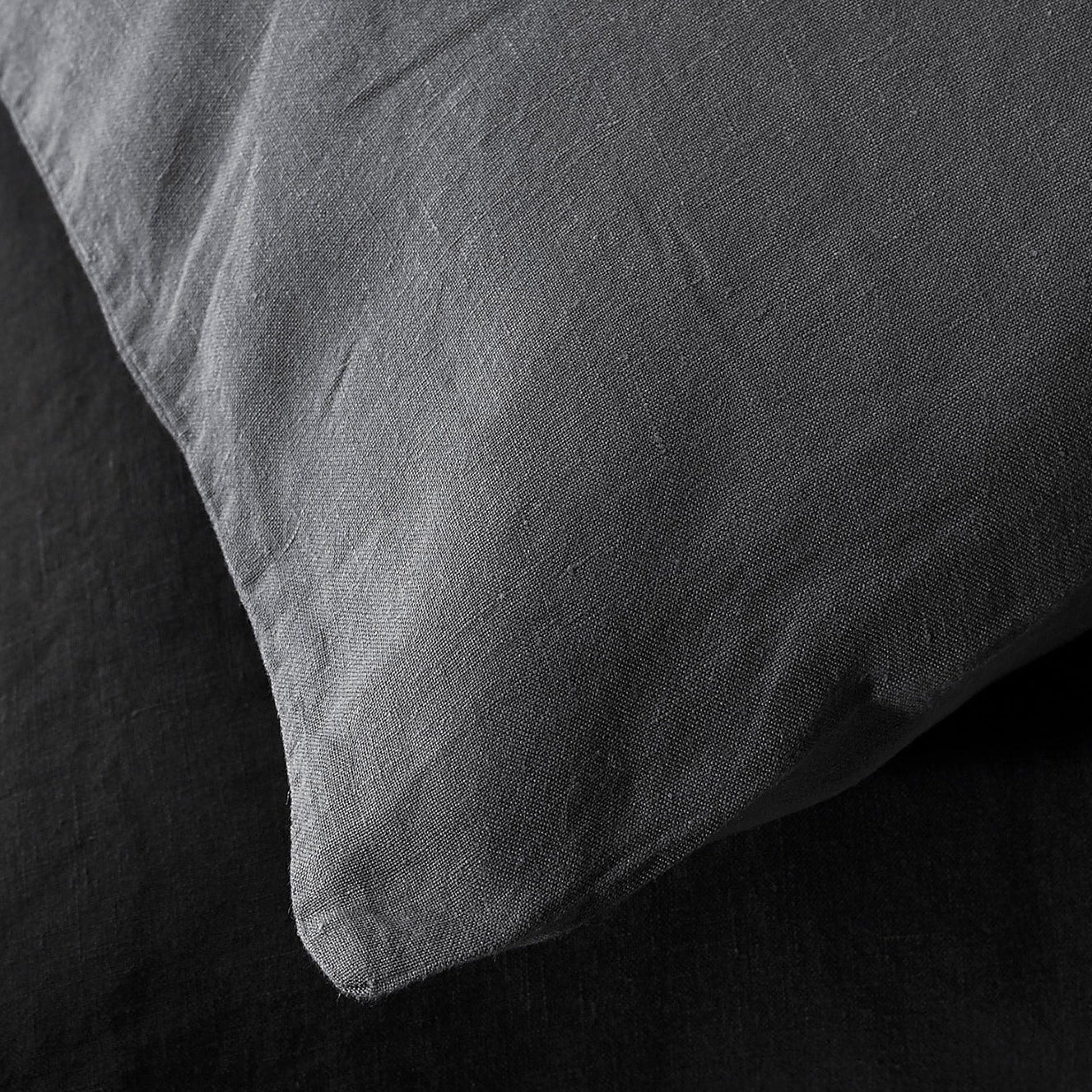 Close-up of Society Limonta Rem pillowcase corner in slate linen, showing natural texture.