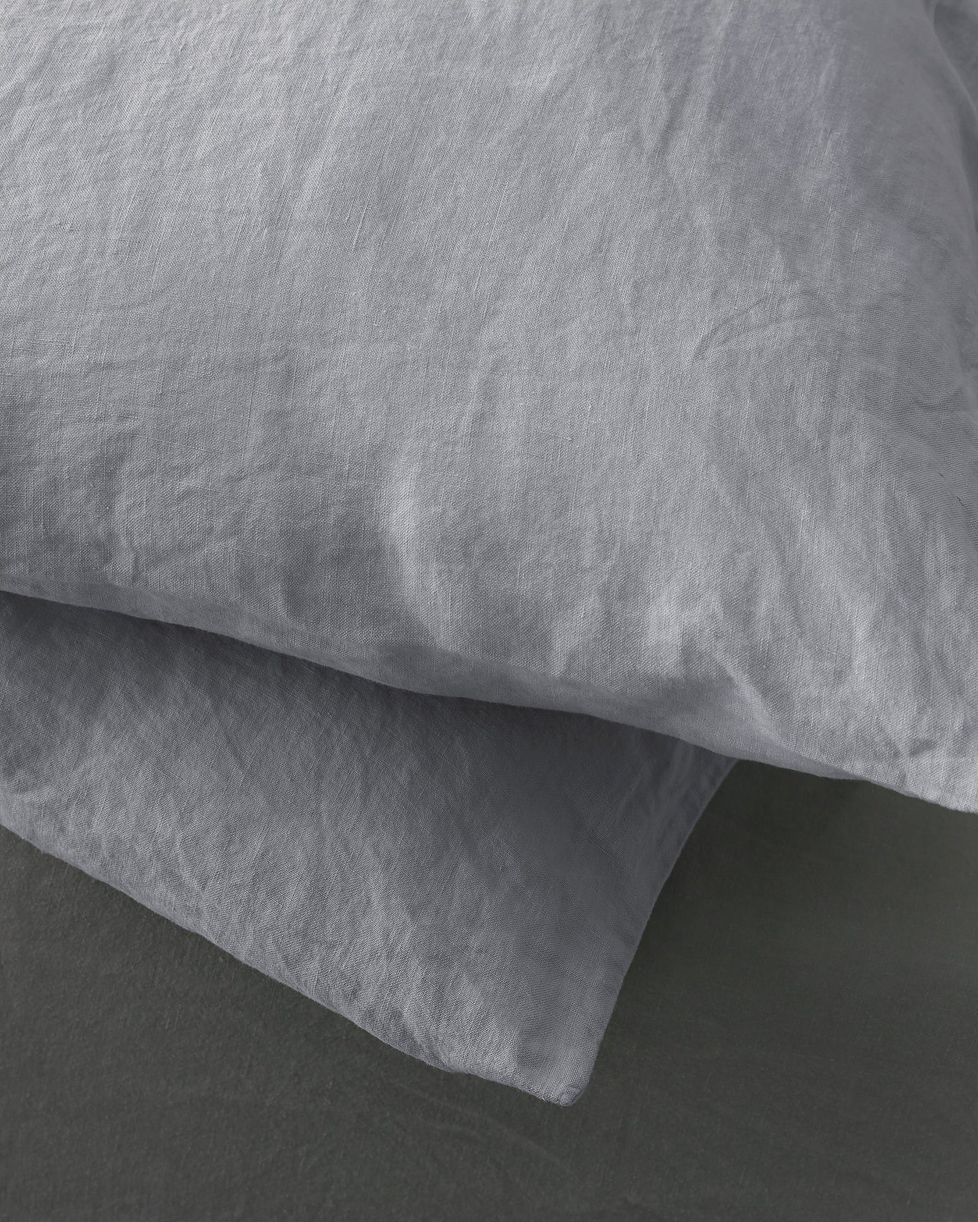 Close-up of Society Limonta Rem pillowcase set in dove grey washed linen texture.