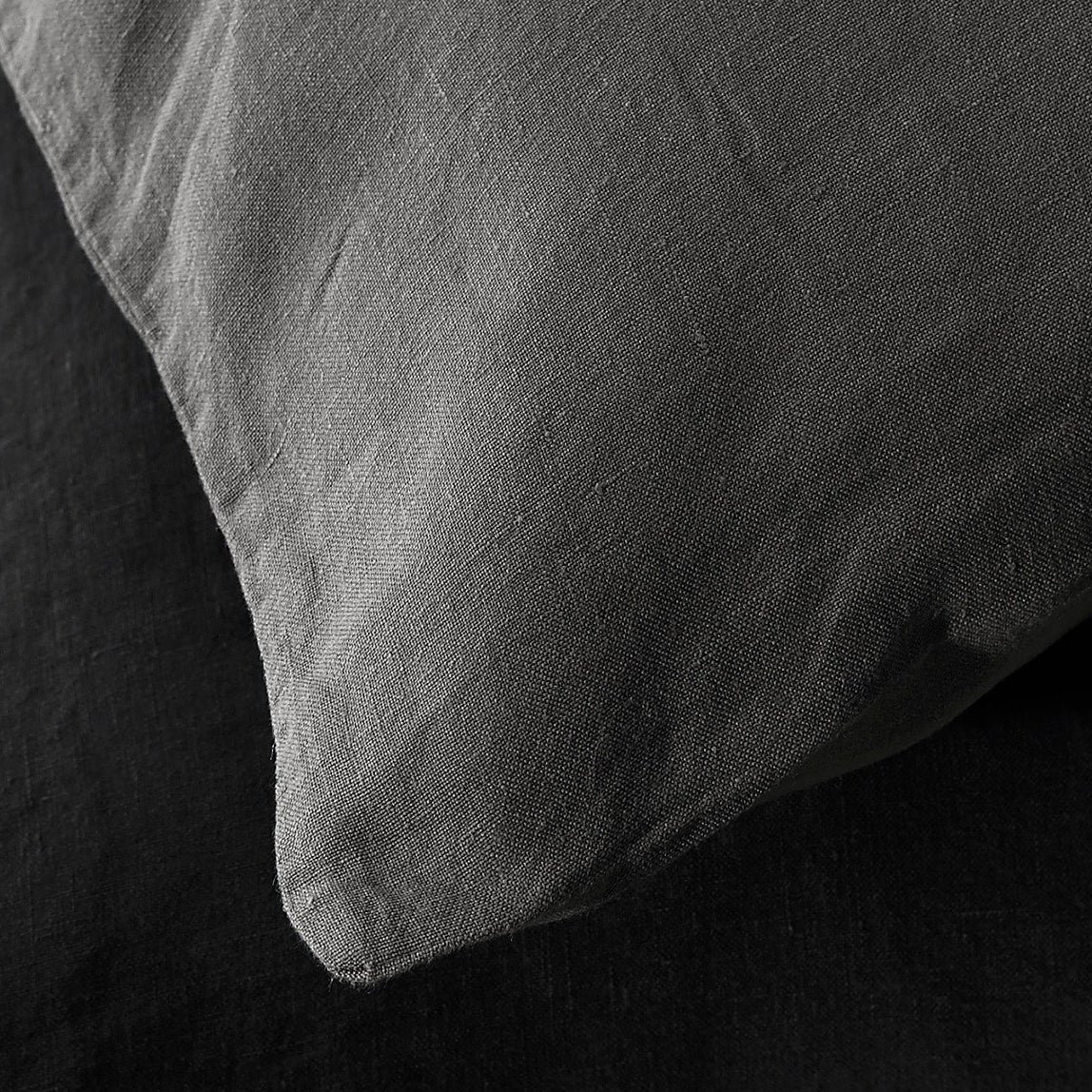 Close-up of Society Limonta Rem pillowcase corner in ash grey washed linen.