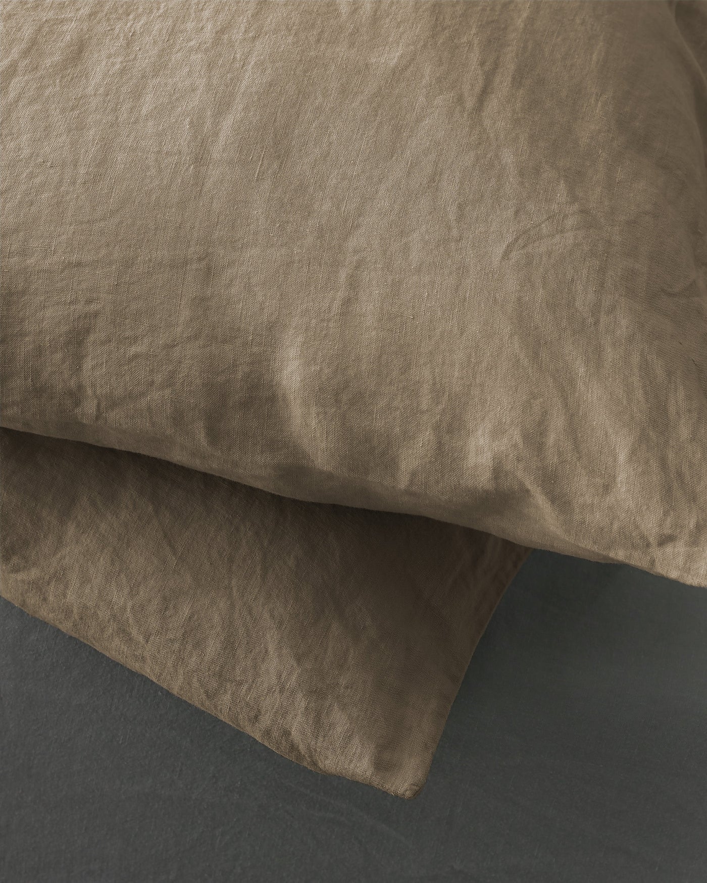 Close-up of Society Limonta Rem pillowcase in taupe, showing relaxed linen texture.