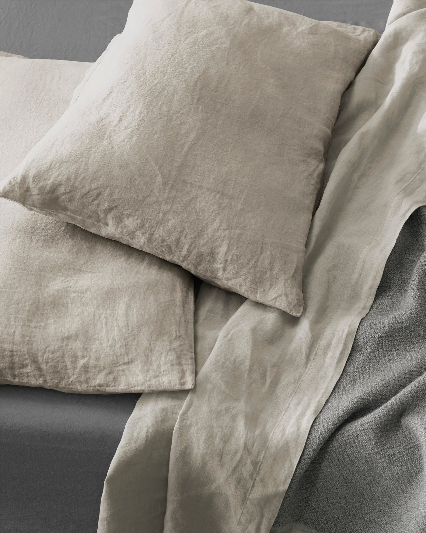 Close-up of Society Limonta Rem pillowcases in sand, showing relaxed washed linen texture.