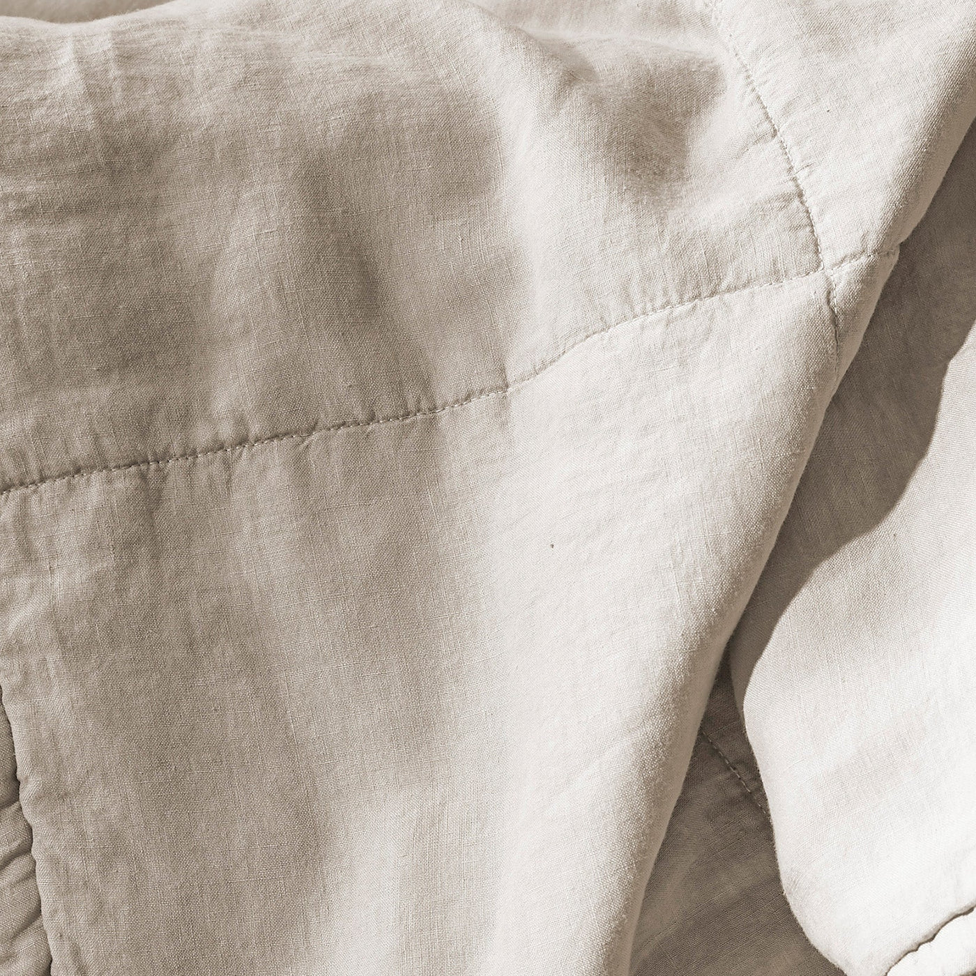 Close-up of Society Limonta Rem quilt showing diamond quilting stitches in natural linen.