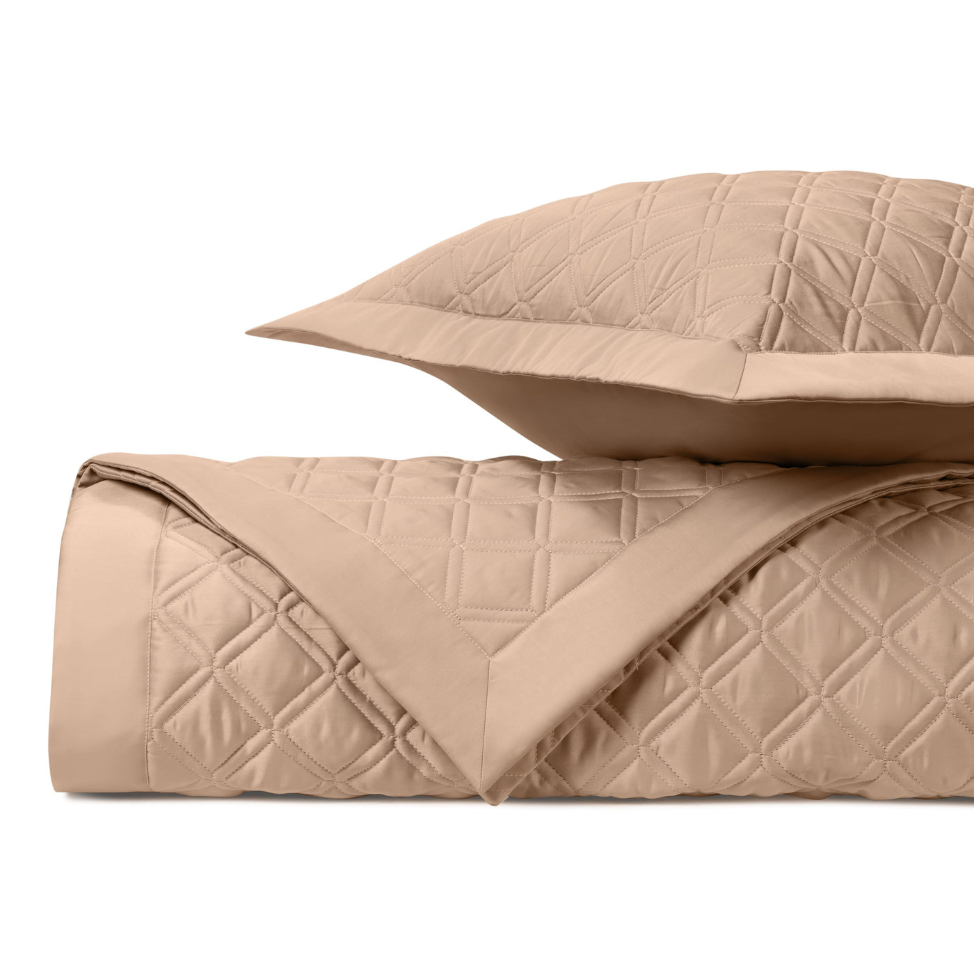 Caramel quilted coverlet and sham folded, showing diamond stitching pattern and smooth reverse.