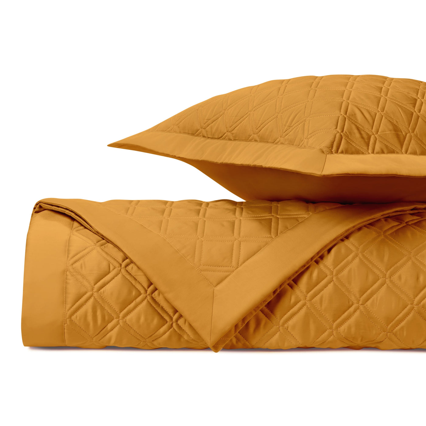 Close-up of Renaissance quilted coverlet in amber with diamond stitching pattern.