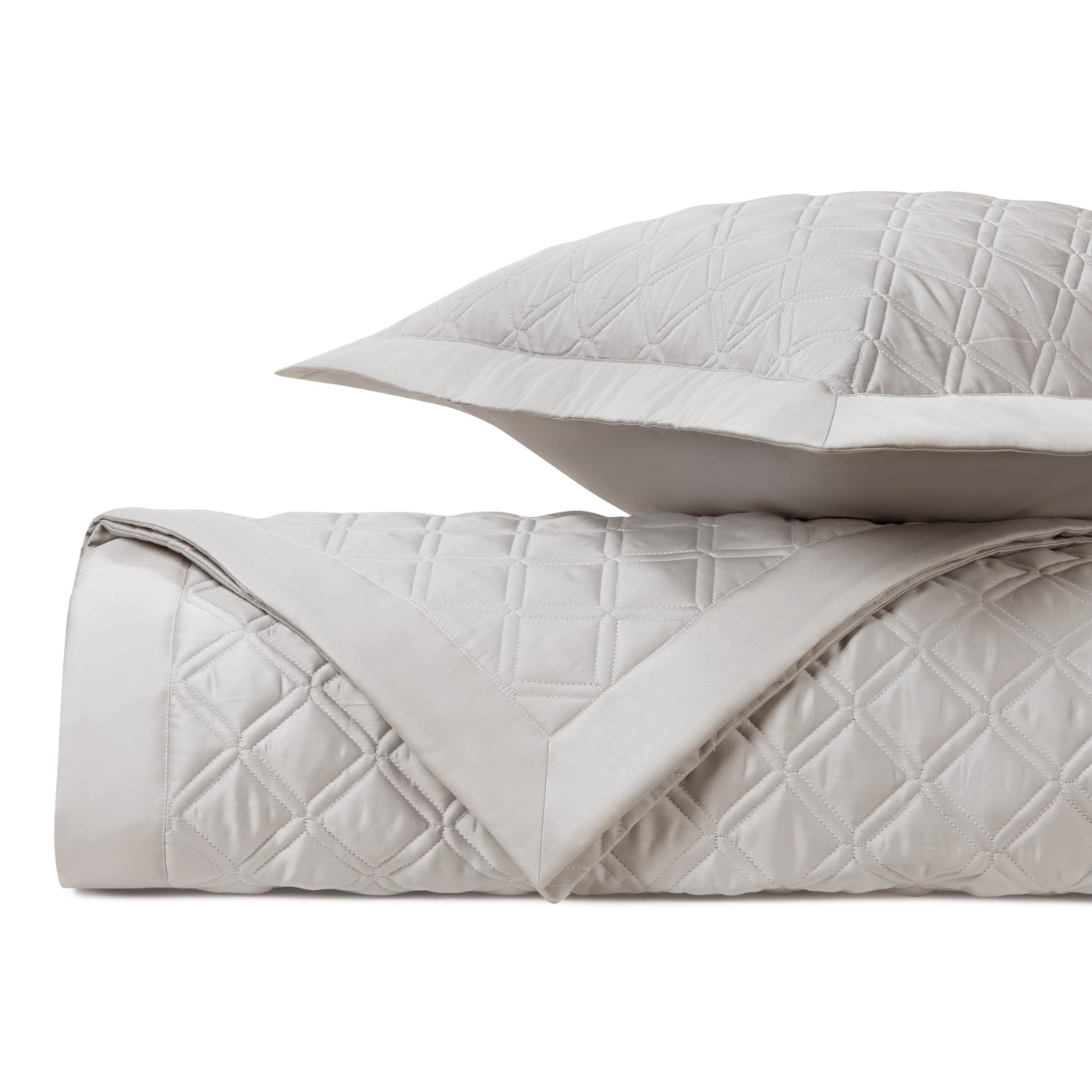 Close-up of Renaissance quilted satin in pearl, showing diamond stitching texture.