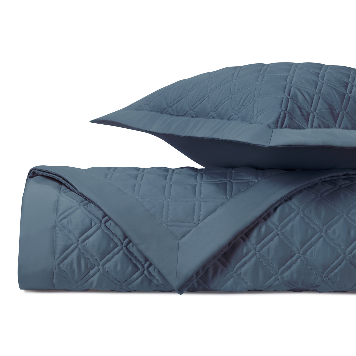 Close-up of slate blue quilted diamond stitching on Home Treasures Renaissance coverlet and sham.