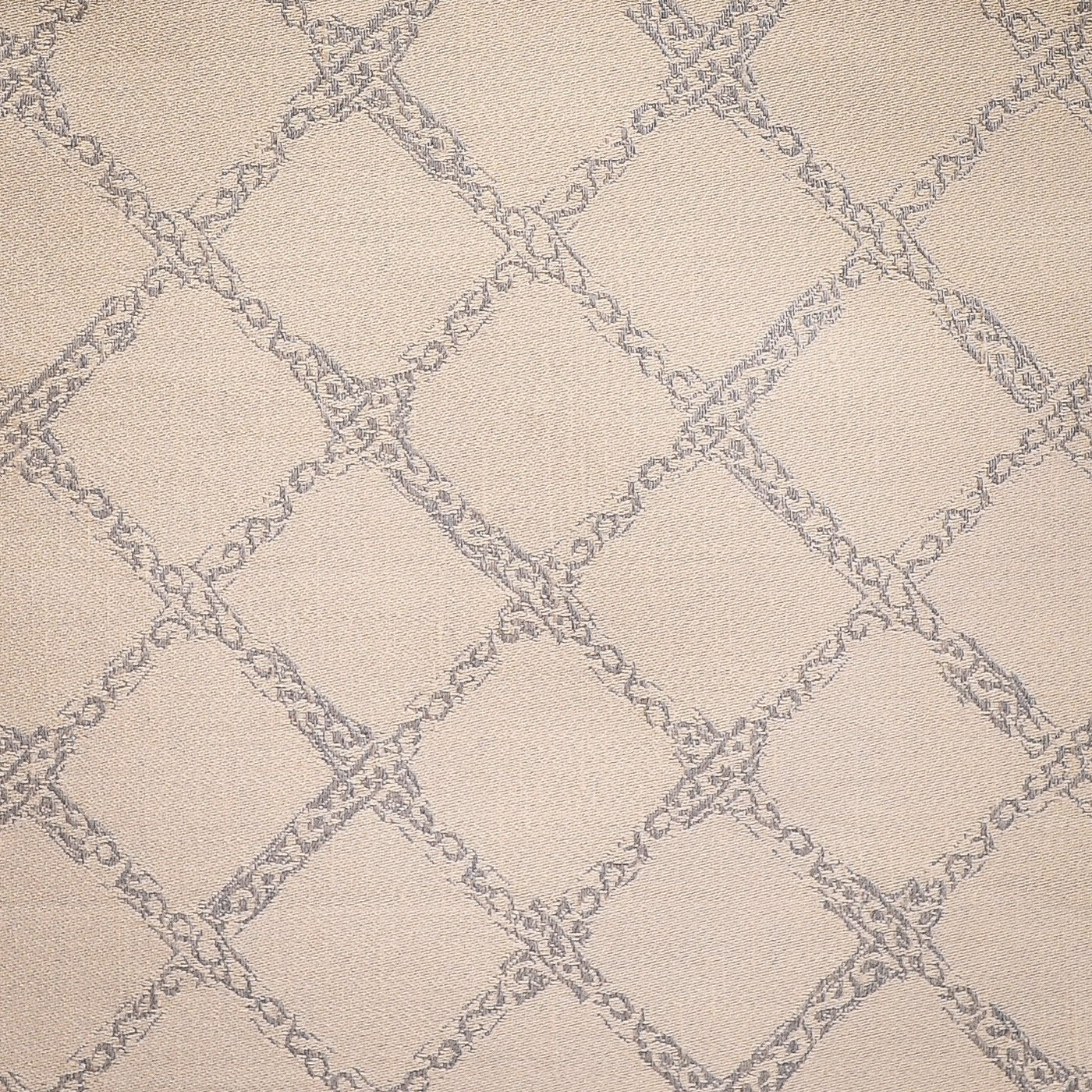 Close-up of Renaissance ivory fabric with silver lattice and scrollwork jacquard pattern.