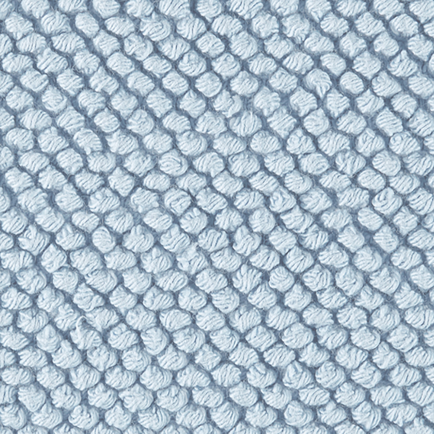 Close-up of Matouk Reverie bath rug in powder blue showing textured loop weave pattern.