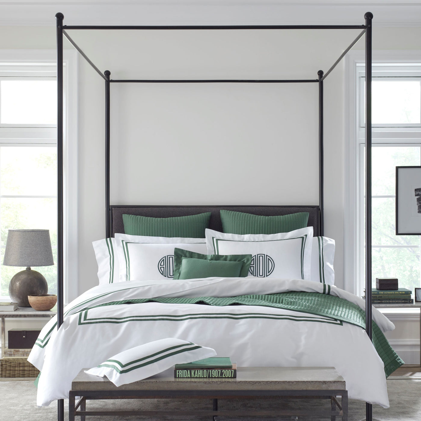 Home Treasures Ribbons bedding in white with forest green border on four-poster bed.