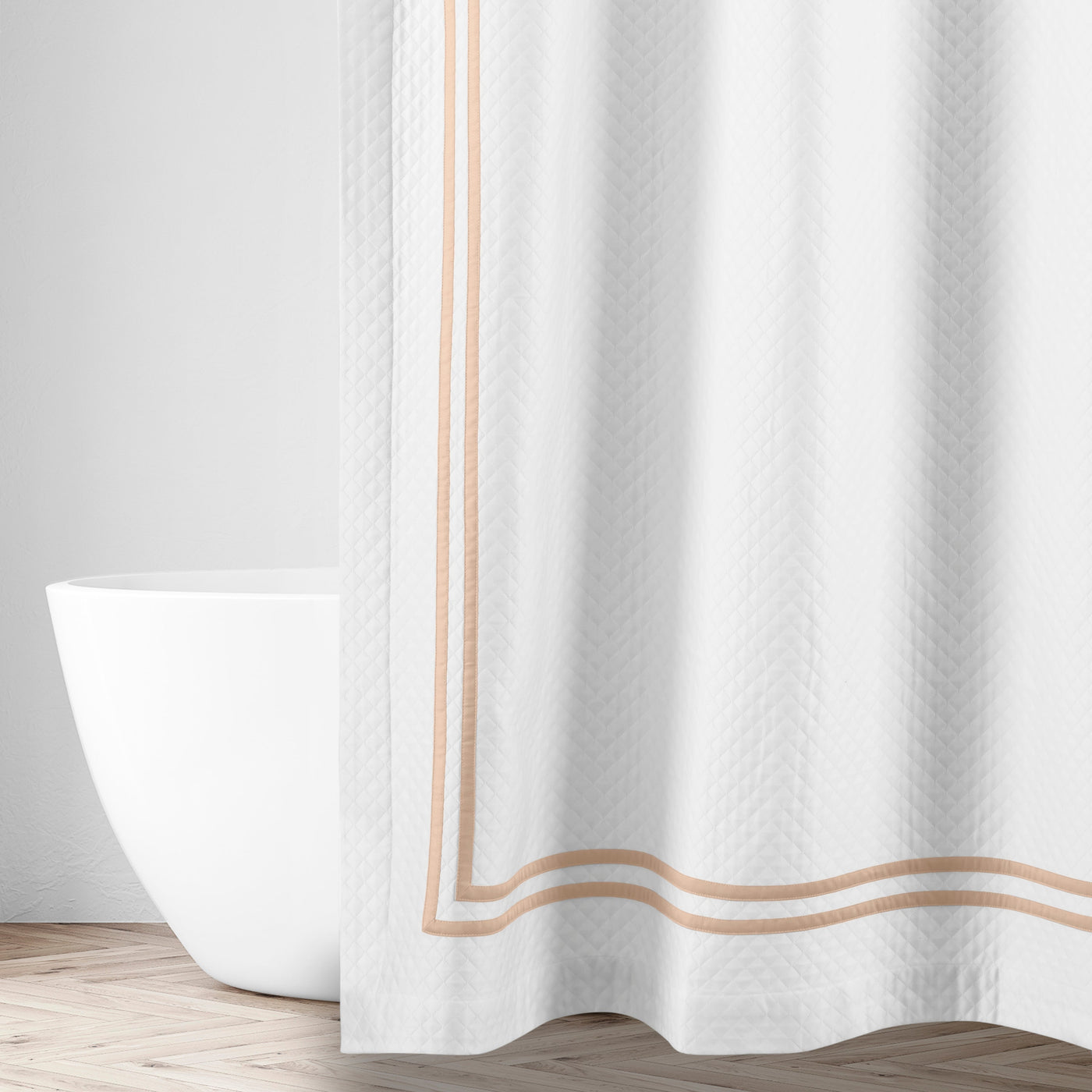 Close-up of white textured fabric with double champagne border trim detail.