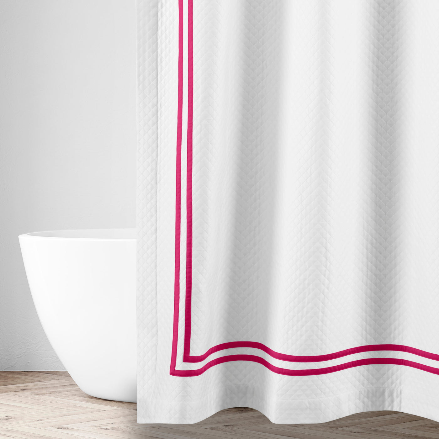 Close-up of white matelassé fabric with double raspberry ribbon border trim detail.