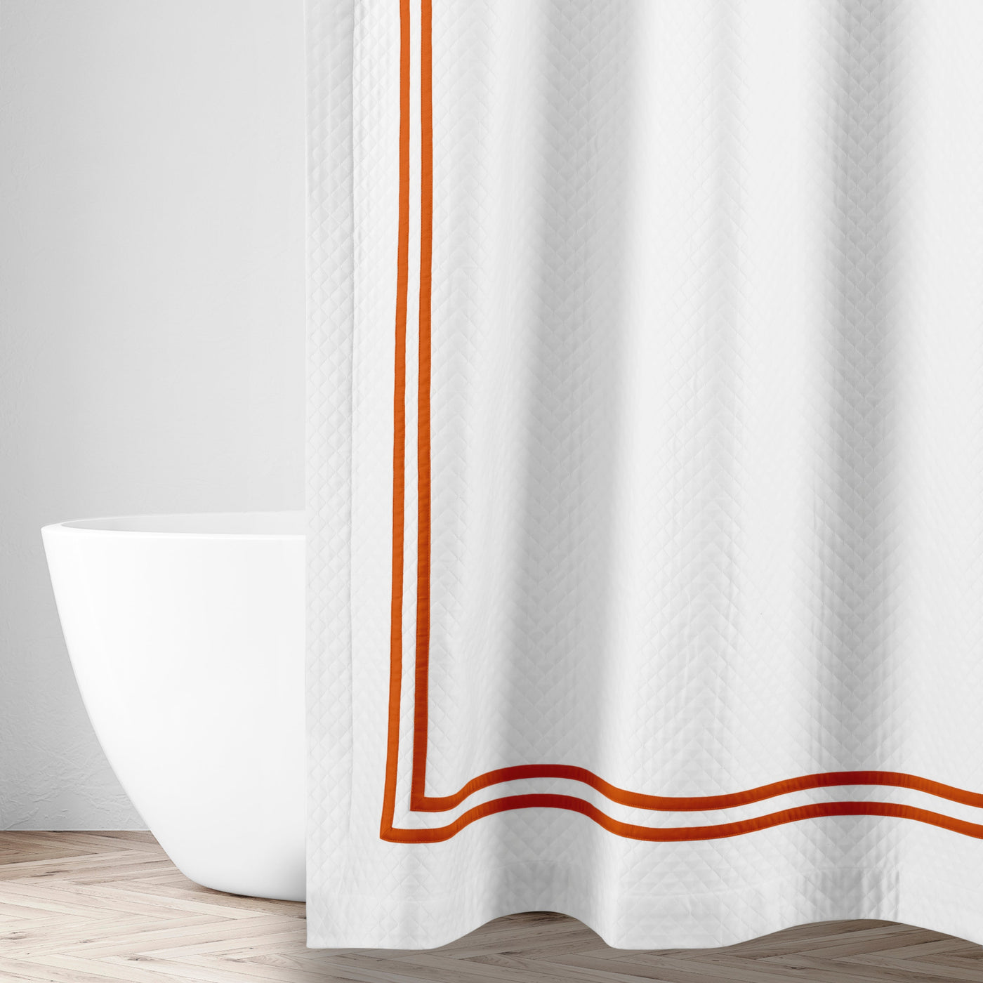 Close-up of Home Treasures Ribbons shower curtain hem with burnt orange double-stripe border.