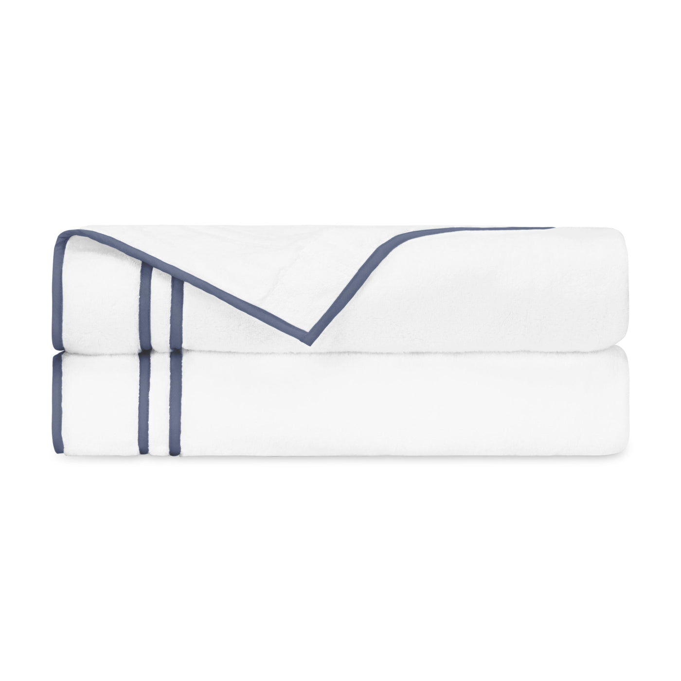 White cotton pillowcases folded with double navy grosgrain ribbon trim detail.
