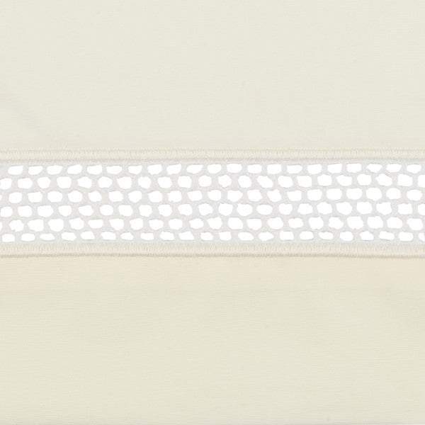 Close-up of ivory linen pillow sham hem with white honeycomb lace trim detail.