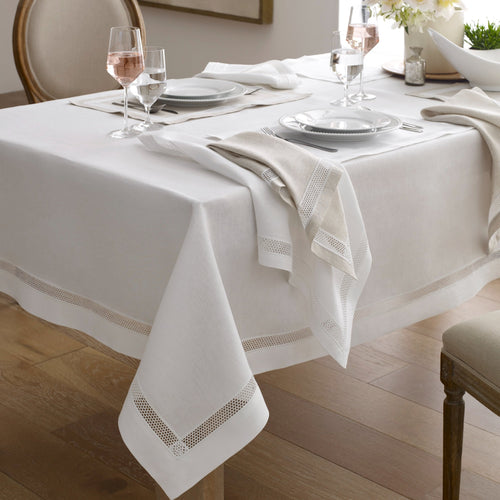 Home Treasures Ritz white linen tablecloth with hemstitch border on a set dining table.