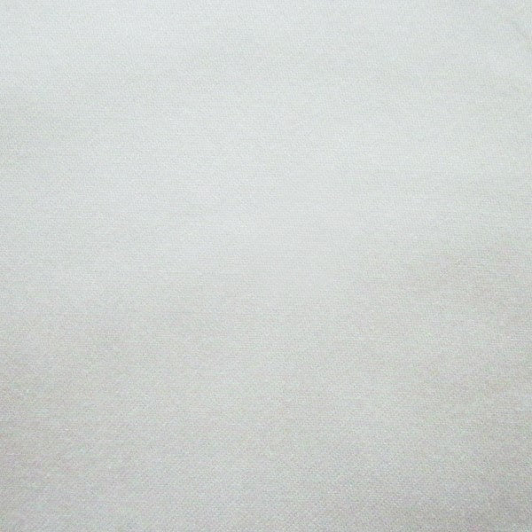 Close-up of ivory woven linen fabric showing fine texture and subtle sheen.