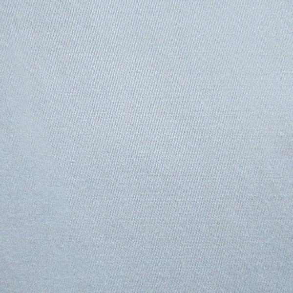 Close-up of pale blue woven cotton fabric texture.