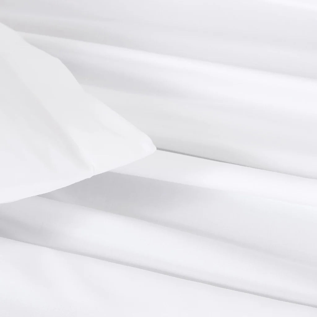Frette Sateen Pillowcase Set by Frette arranged on a bed, paired with a luxurious duvet cover for the ultimate luxury bedding experience.