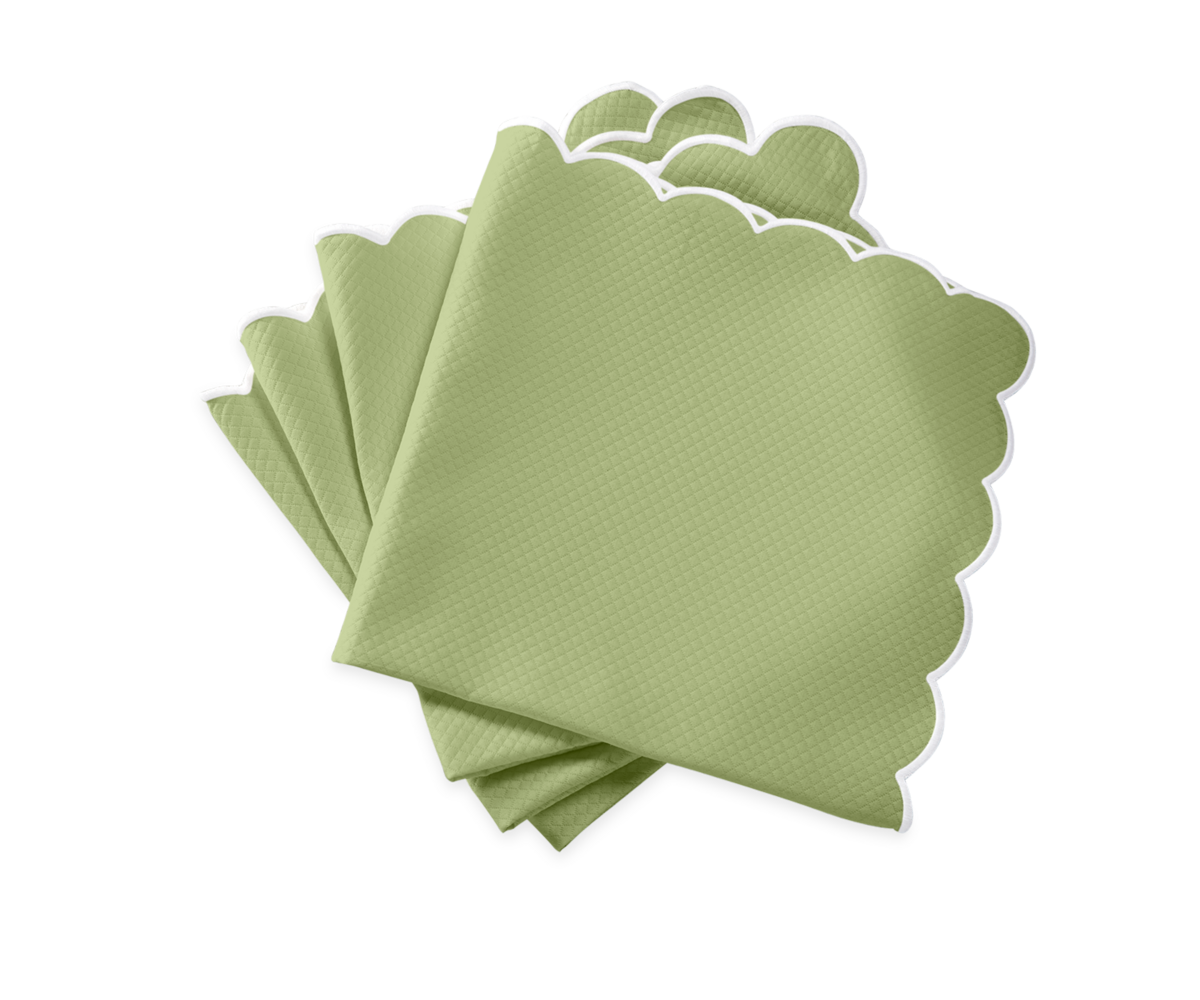 A set of five light green Savannah Gardens napkins by Matouk, featuring a subtle texture and white scalloped edges, neatly fanned on a white background—an elegant accent for your Matouk table linens.