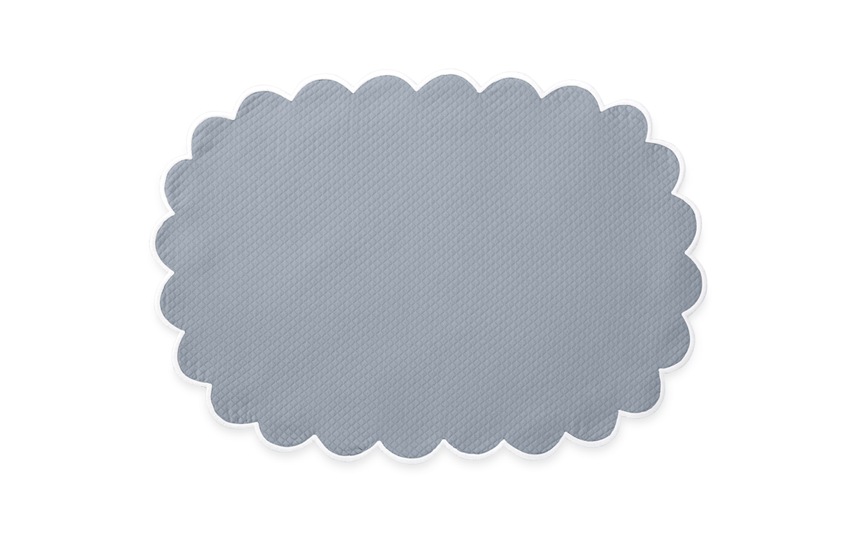 The Savannah Gardens Placemat Set by Matouk features a gray oval design with scalloped edges and white trim in a diamond pique style, reminiscent of classic Matouk table linens, shown on a plain light background.