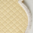 Close-up of Matouk's Savannah Gardens tablecloth, showcasing beige diamond pique quilted fabric with a diamond pattern and white stitched edging—perfect for easy-care table linens.