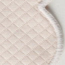 Close-up of the Savannah Gardens Tablecloth by Matouk, featuring quilted, light-colored diamond pique fabric and a stitched scalloped edge—an elegant and easy-care choice for table linens.