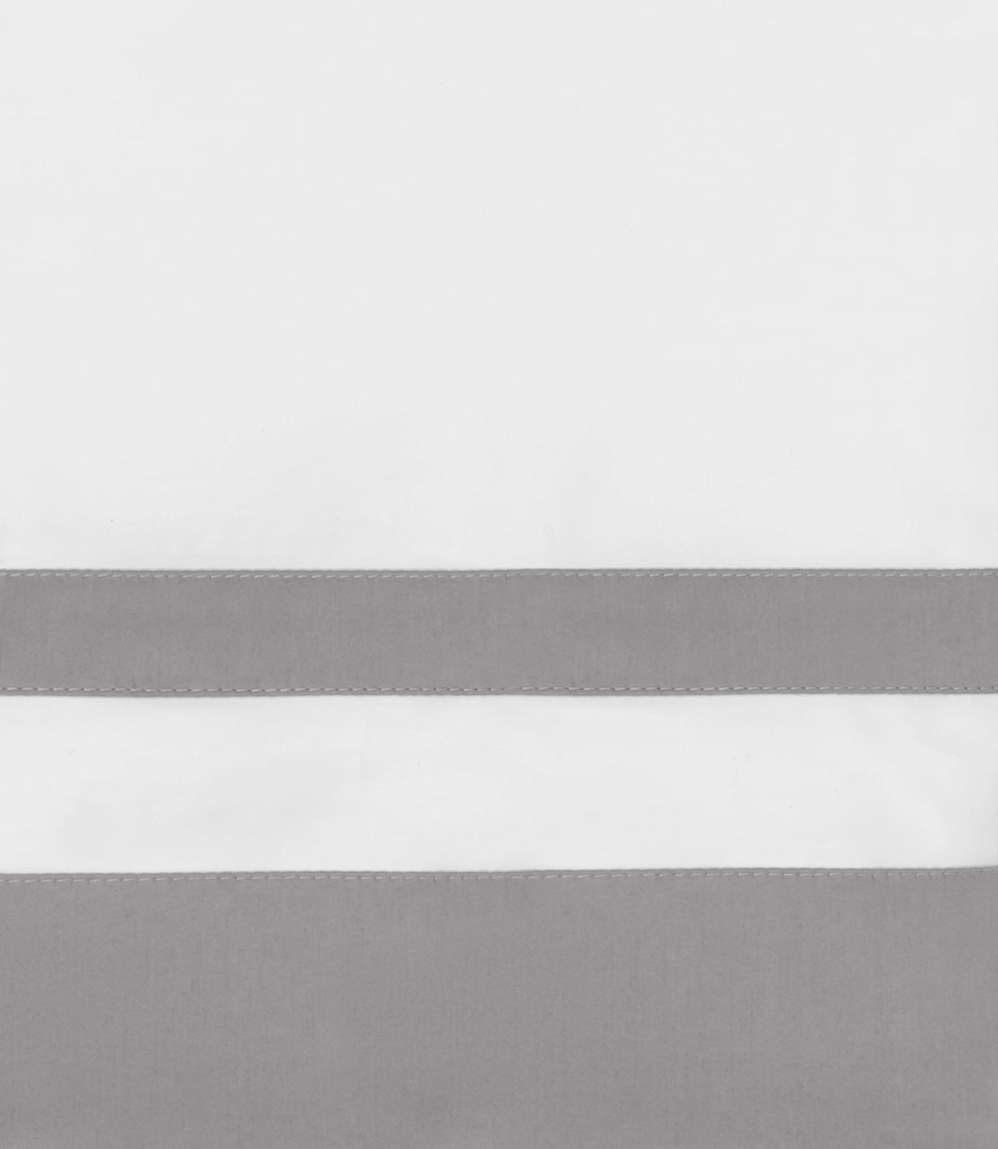 Close-up of white cotton pillow sham with dual silver-grey horizontal border bands.